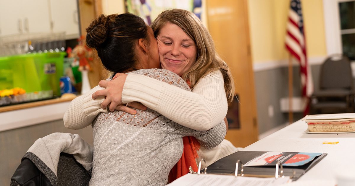 Augusta, ME, United States -- Courtney Allen hugs Eleanor Trask, as they both celebrate 3-year anniversaries not using drugs, at a Young People in Recovery (YPR) meeting at South Parish Congregational Church UCC in Augusta, ME on Tuesday, November 6, 2018. (Photo by Yoon S. Byun)